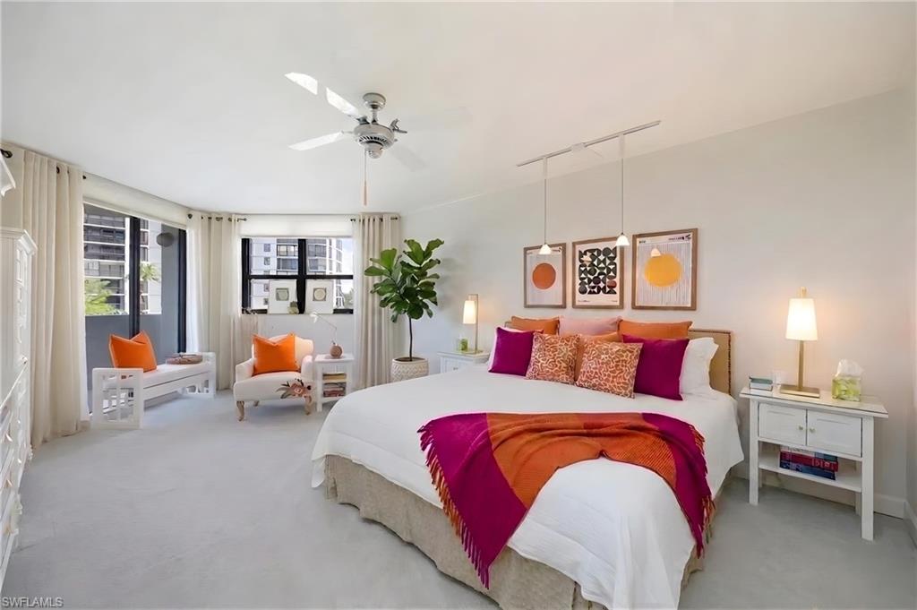 Expansive room featuring light-toned carpeting and multiple windows