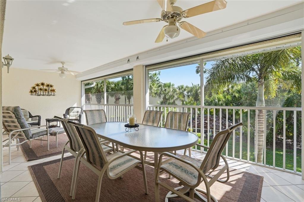Screened outdoor lanai featuring tile flooring and ceiling fans