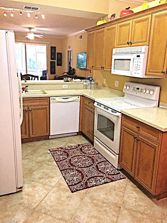 Tiled kitchen with Classic Wooden Cabinets.
