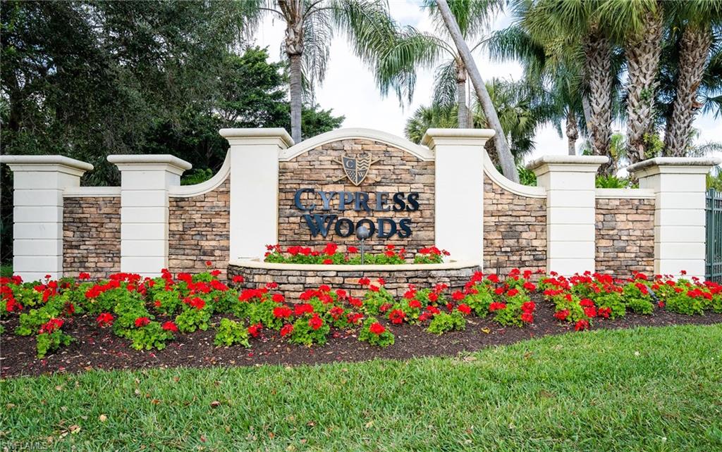 Community / neighborhood sign featuring a lawn