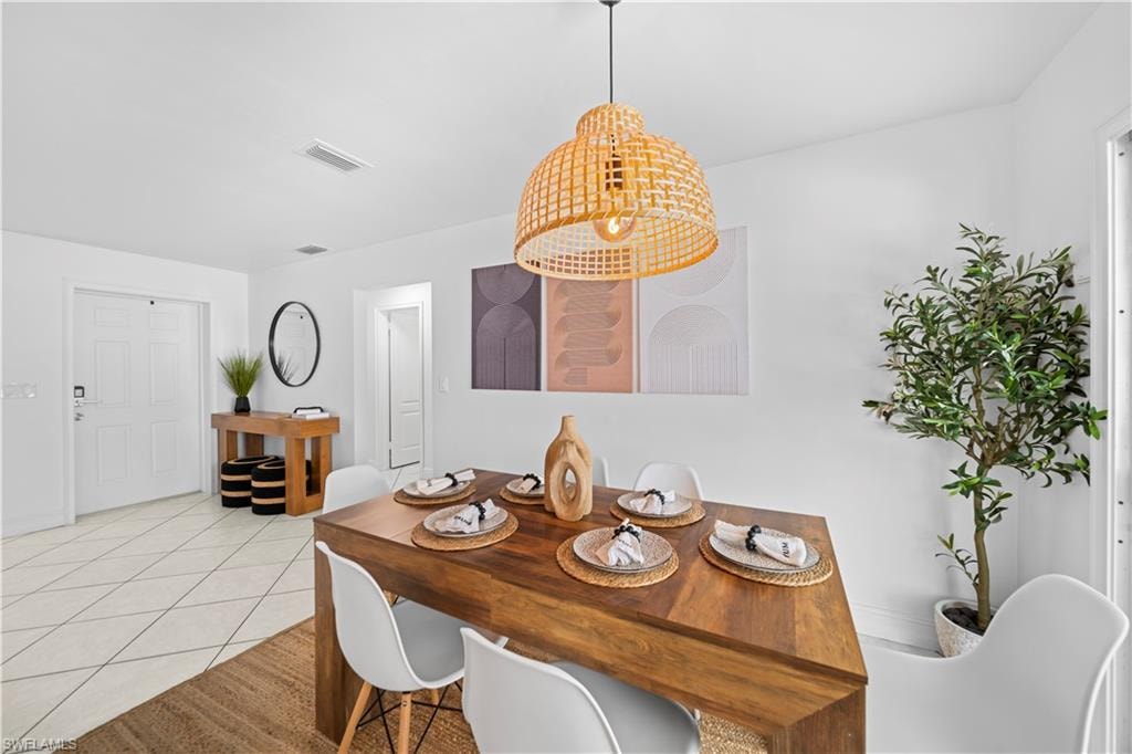 Open dining area featuring a geometric wood-finish dining table and a woven pendant light fixture