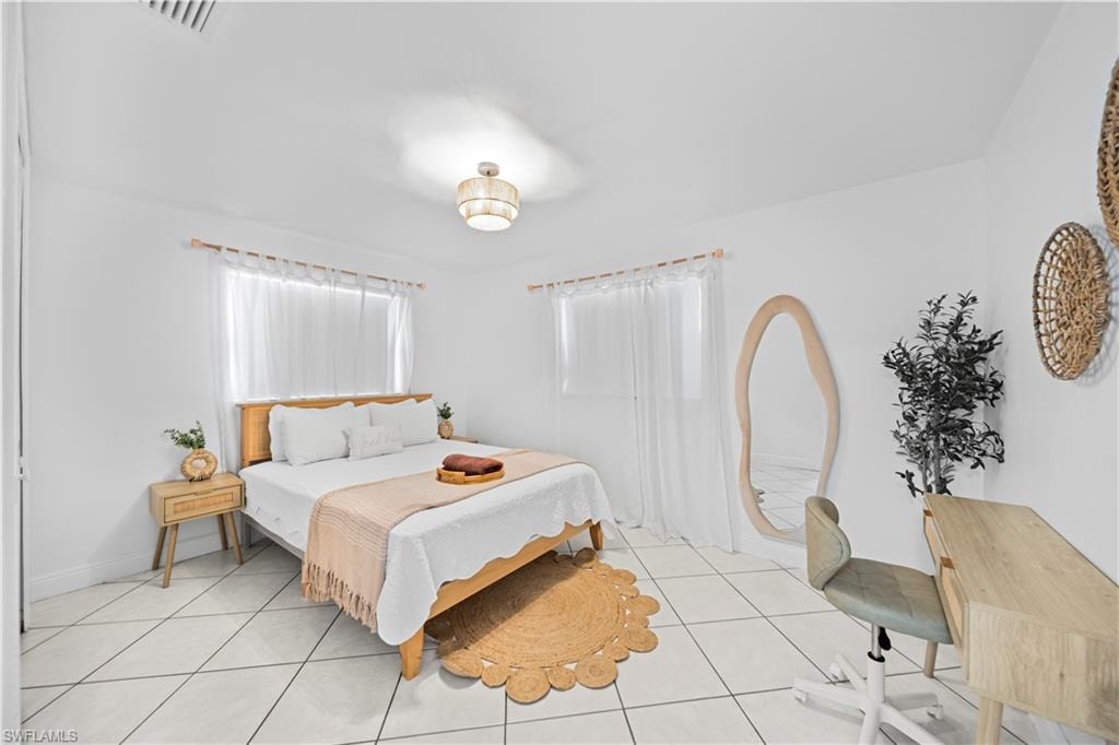 Bright room featuring white tile flooring and white walls