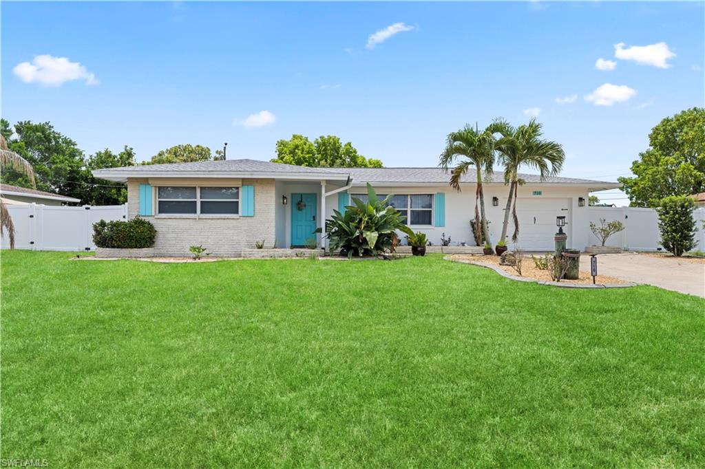Ranch-style exterior with a clean white facade and contrasting turquoise accents