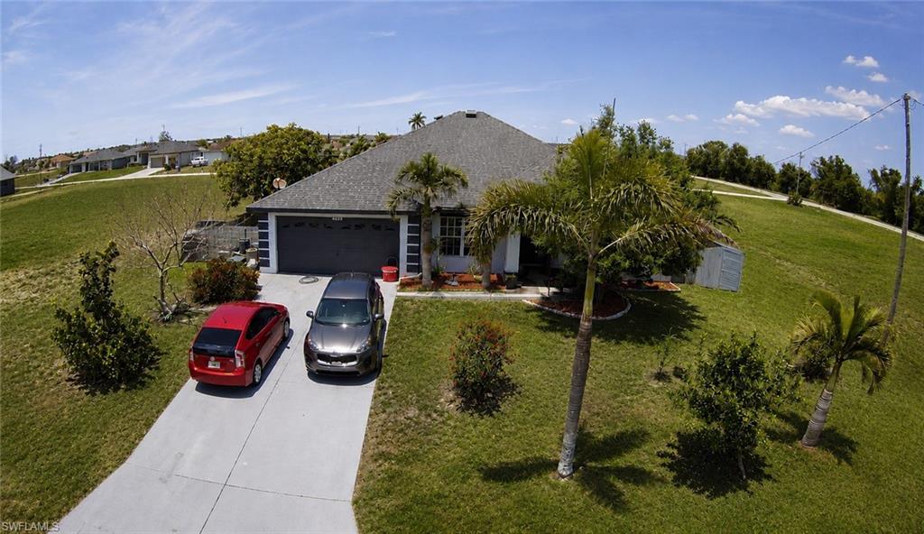 Single-story residence featuring a gray shingle roof and a two-car garage