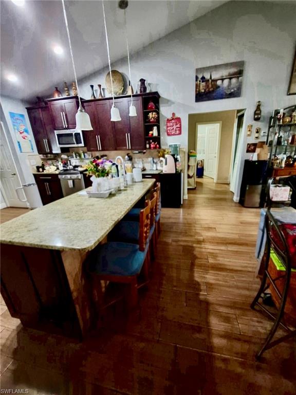 Kitchen featuring vaulted ceilings and recessed lighting