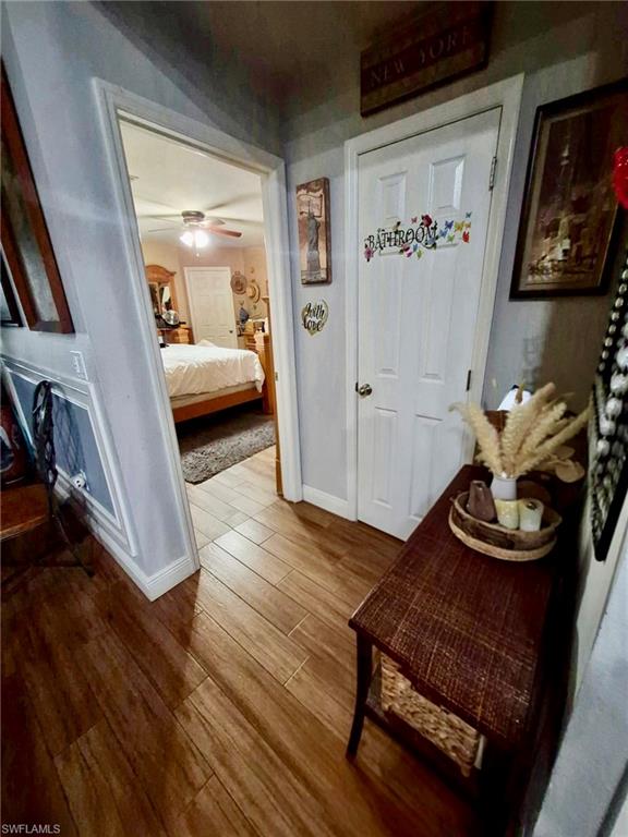 Wood-finish flooring throughout, featuring light gray walls and white trim