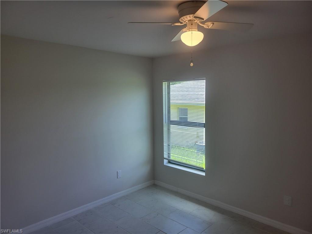 Spare room with ceiling fan