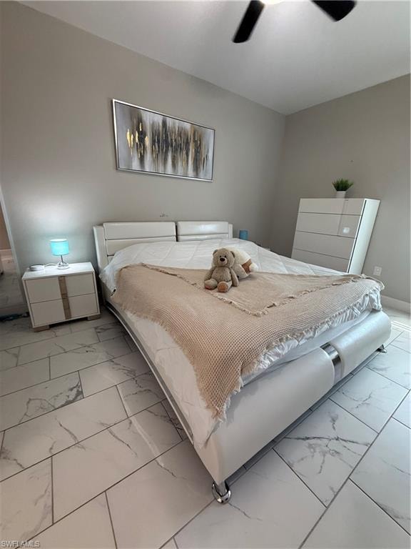 Spacious interior featuring large format tile flooring, a ceiling fan, and light-toned walls