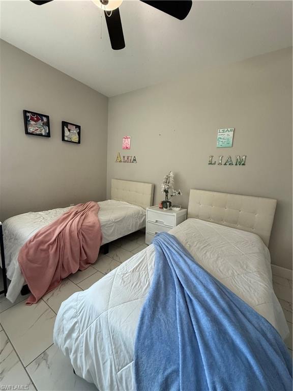 Room featuring a ceiling fan, light-toned walls, and a tiled floor