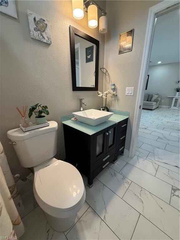 Bathroom vanity featuring a vessel sink, dark wood-finish cabinetry, and a glass countertop