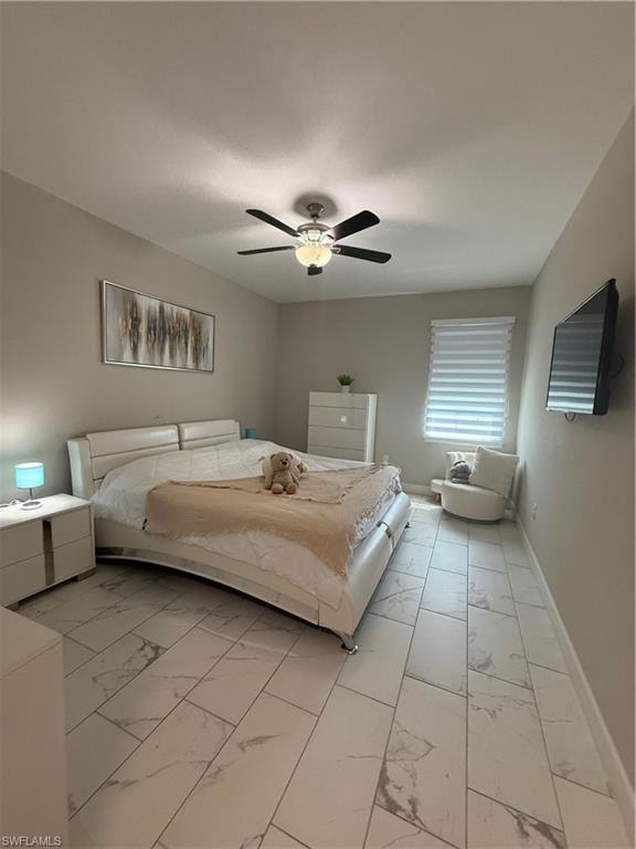 Spacious room featuring large format tile flooring and a ceiling fan with integrated lighting