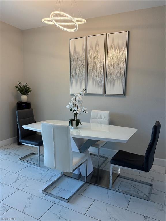 Recessed lighting and a modern chandelier illuminate the rectangular dining area