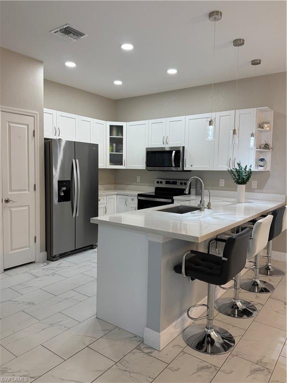 Modern kitchen featuring white shaker cabinetry and a large island with countertop seating