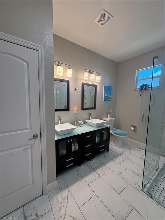 Bathroom featuring a dual vanity with vessel sinks, a glass-enclosed shower, a toilet, and large format marble-look tile flooring