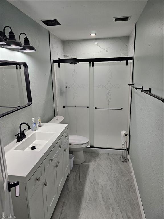 Bathroom with vanity, toilet, and an enclosed shower