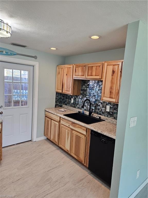 Kitchen featuring dishwasher, decorative backsplash, a textured ceiling, and sink