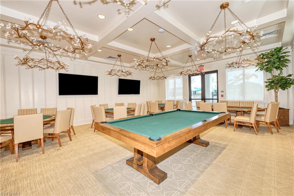 Recreation room with beamed ceiling, a chandelier, and coffered ceiling
