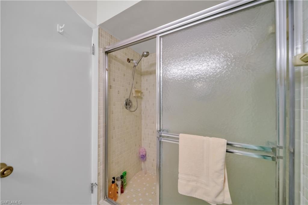 Shower enclosure featuring textured glass sliding doors and a chrome frame