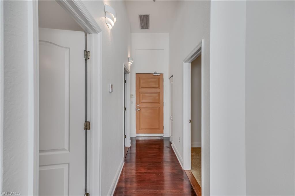 Hallway with dark wood-type flooring