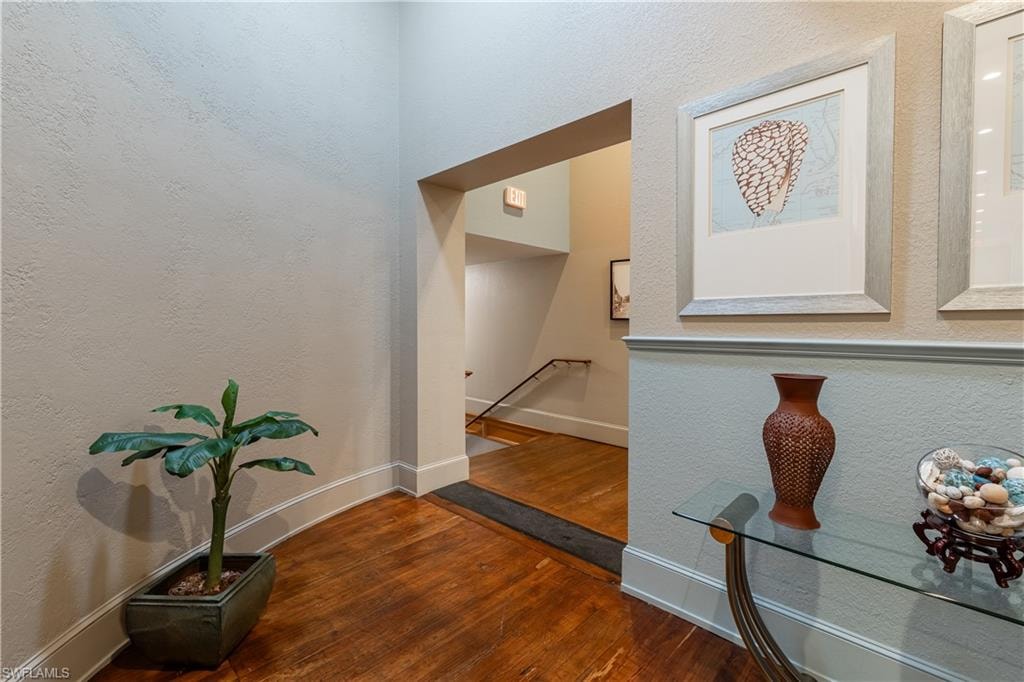 Corridor with dark hardwood / wood-style floors