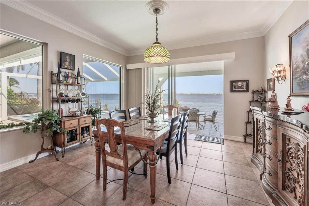 Virtually modified photo-DINING ROOM W/SLIDERS TO LANAI & RIVER VIEW