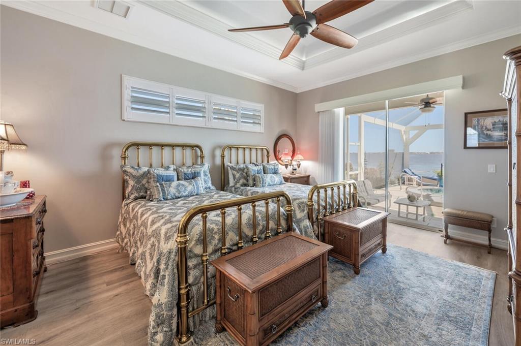 Virtually modified photo-OWNER'S BEDROOM W/LUXURY VINYL FLOORING & SLIDERS TO LANAI & RIVER VIEW