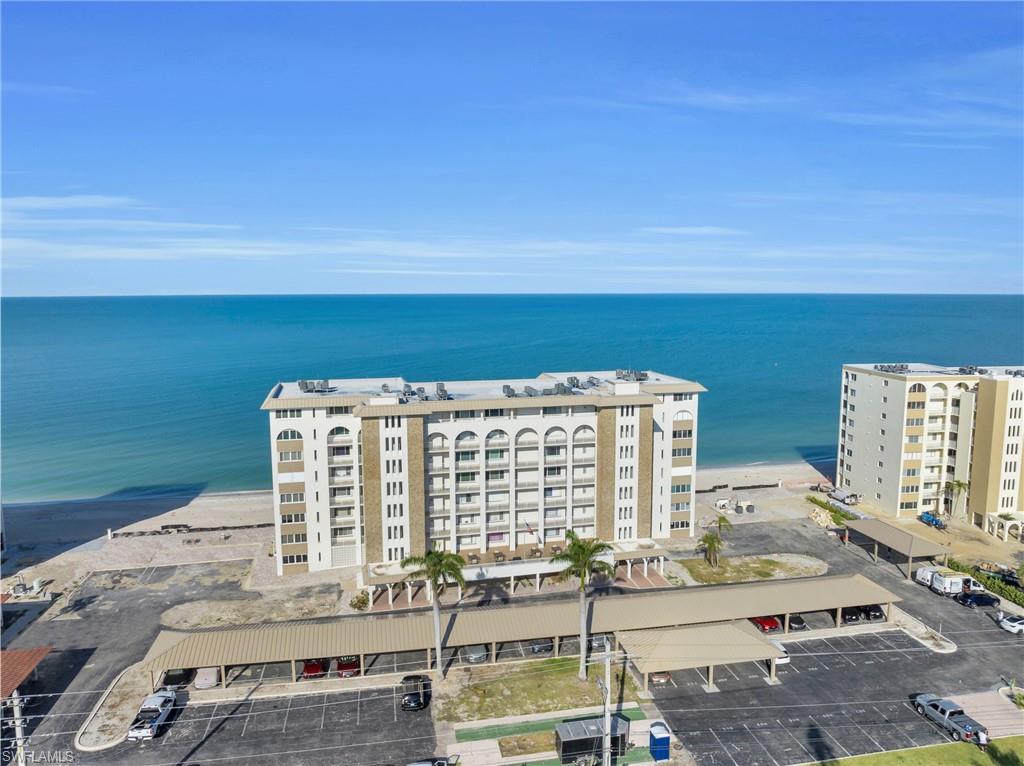Beachfront building featuring multi-story construction and numerous balconies