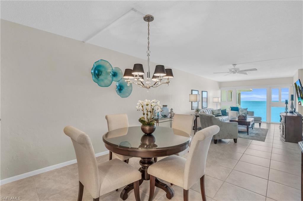 Open-concept living area with tile flooring and bright white walls
