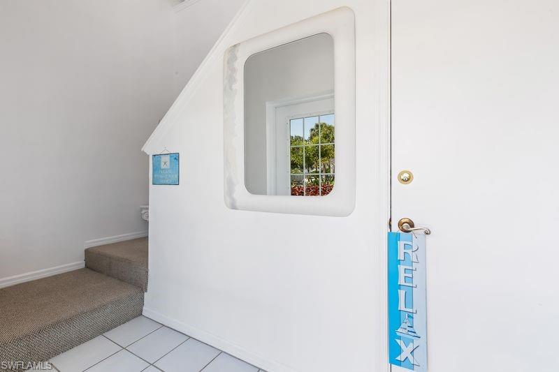 Entrance foyer of the unit with interior stairs up to the unit.