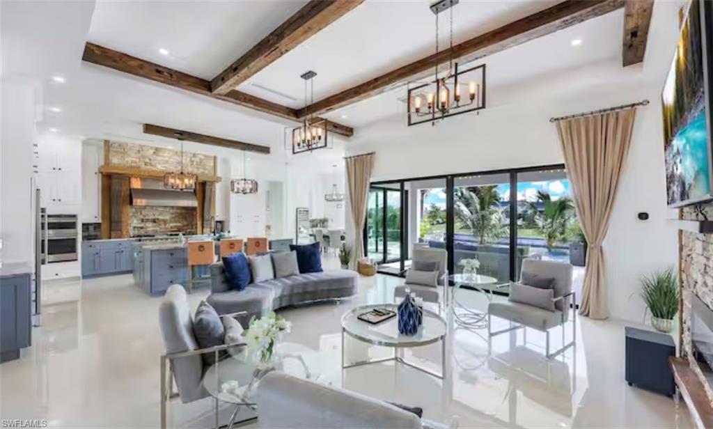 Living area featuring suspended lighting and finished concrete flooring