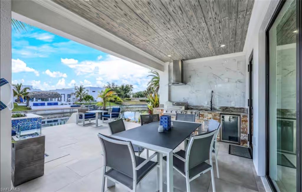 View of patio featuring outdoor dining area and area for grilling
