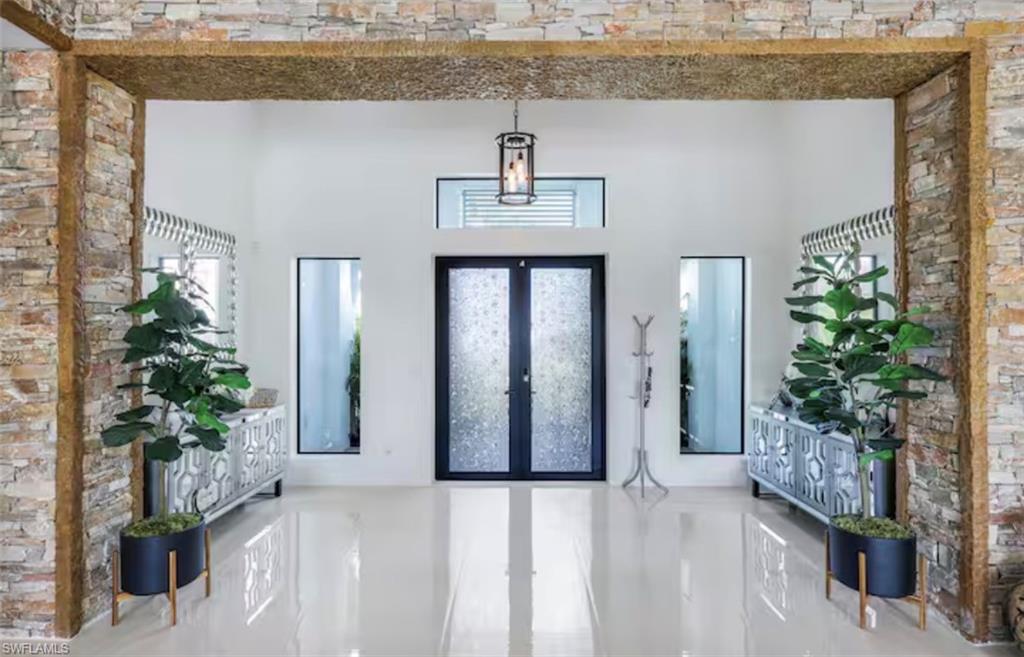 Foyer entrance featuring french doors and a high ceiling