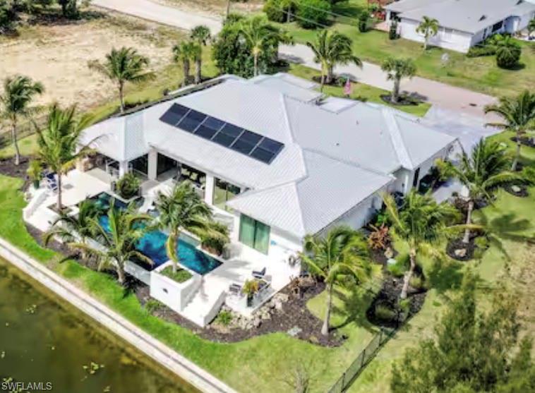 Aerial view of property and surrounding area featuring a pool