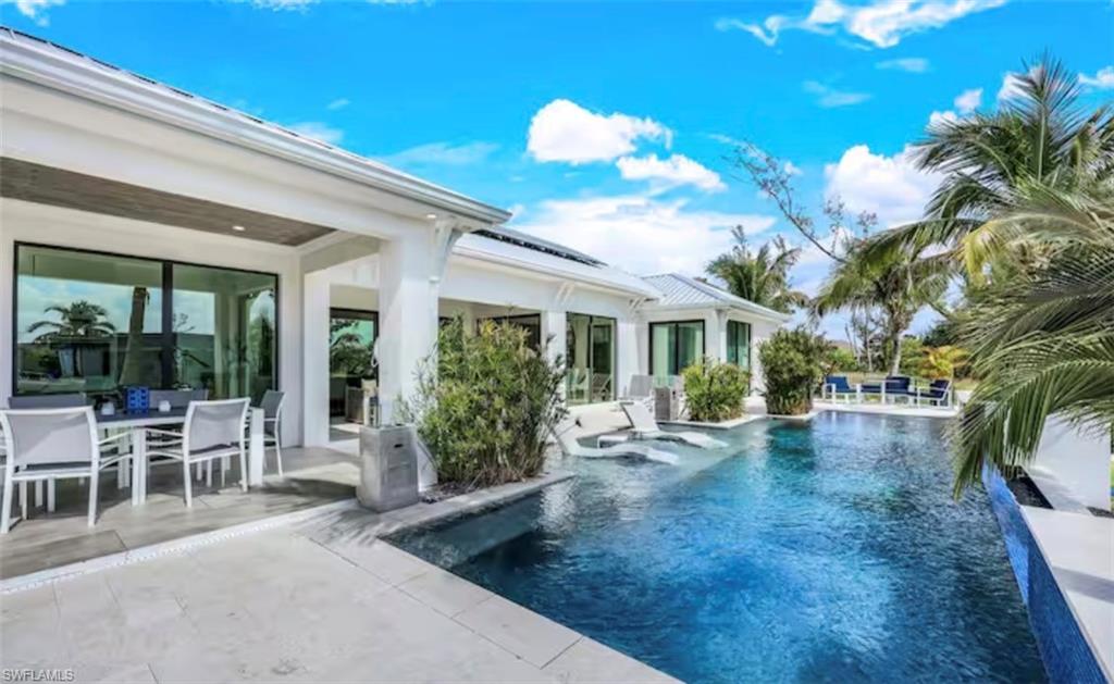Outdoor pool featuring a patio area and outdoor dining space
