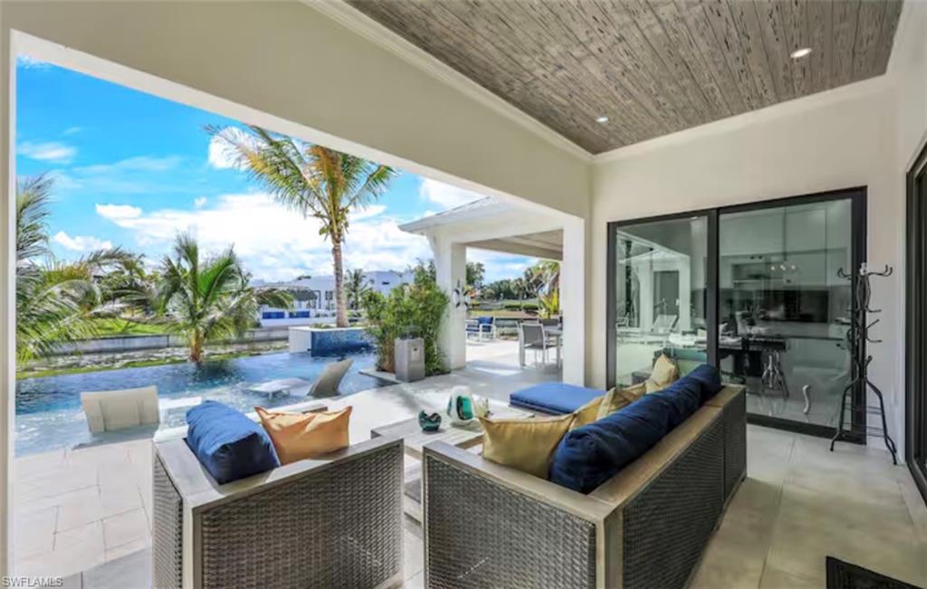 View of patio / terrace featuring an outdoor hangout area, a swimming pool, and a water view