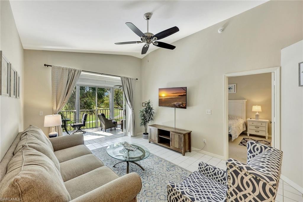 Living area with vaulted ceiling and tiled flooring