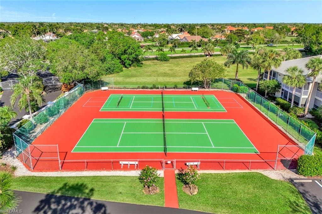 Two tennis courts with red surfacing and green playing areas