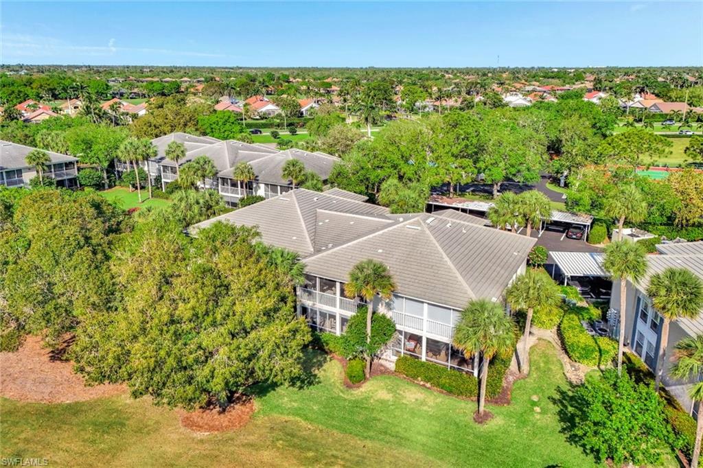 Tile roof structures surrounded by mature trees and manicured lawns