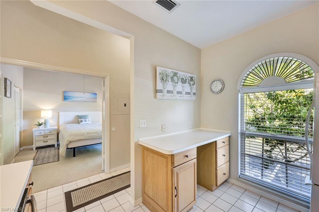 Kitchen area featuring a built-in desk with wood-finish cabinetry and a light-toned countertop
