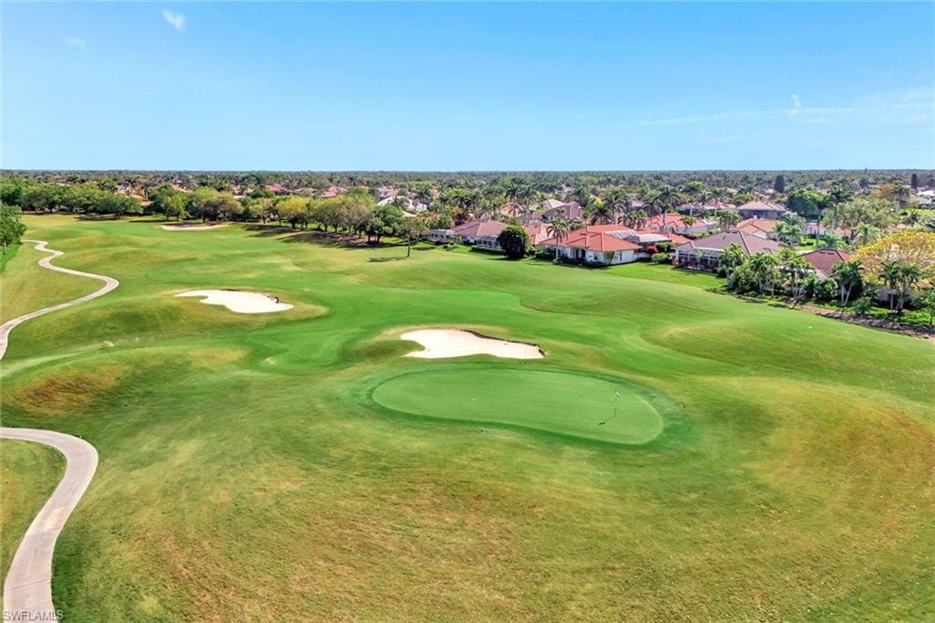 Expansive golf course featuring multiple greens, sand traps, and a cart path
