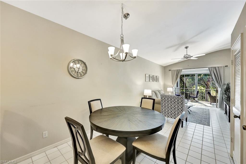Dining area with a round wood-finish table and chandelier lighting