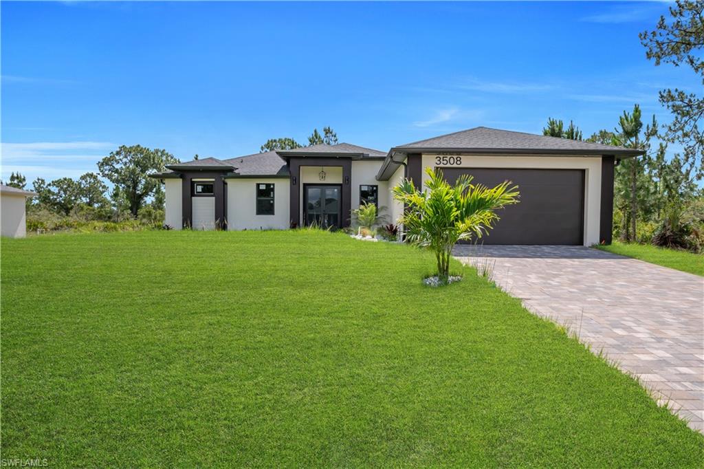 Contemporary single-story residence featuring a dark gray roof, light stucco facade, and dark trim accents