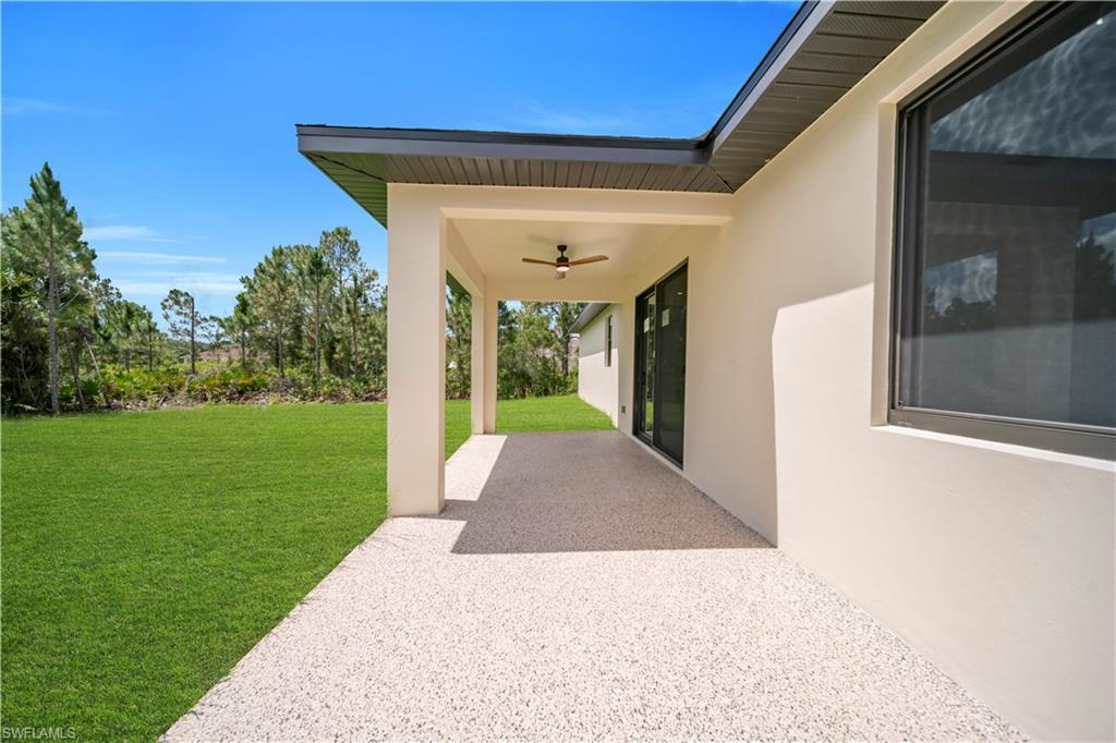 Covered patio featuring an exposed aggregate finish, a ceiling fan, and recessed lighting