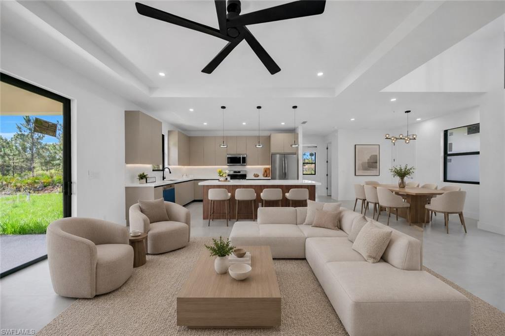 Open-concept living area featuring a modern kitchen, dining area, and living room