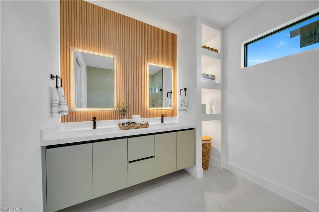 Dual vanity with light gray cabinetry, white countertop, and integrated matte black faucets