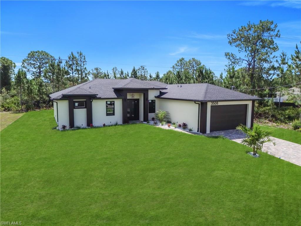 Contemporary single-story residence with a dark shingle roof and light-colored stucco exterior