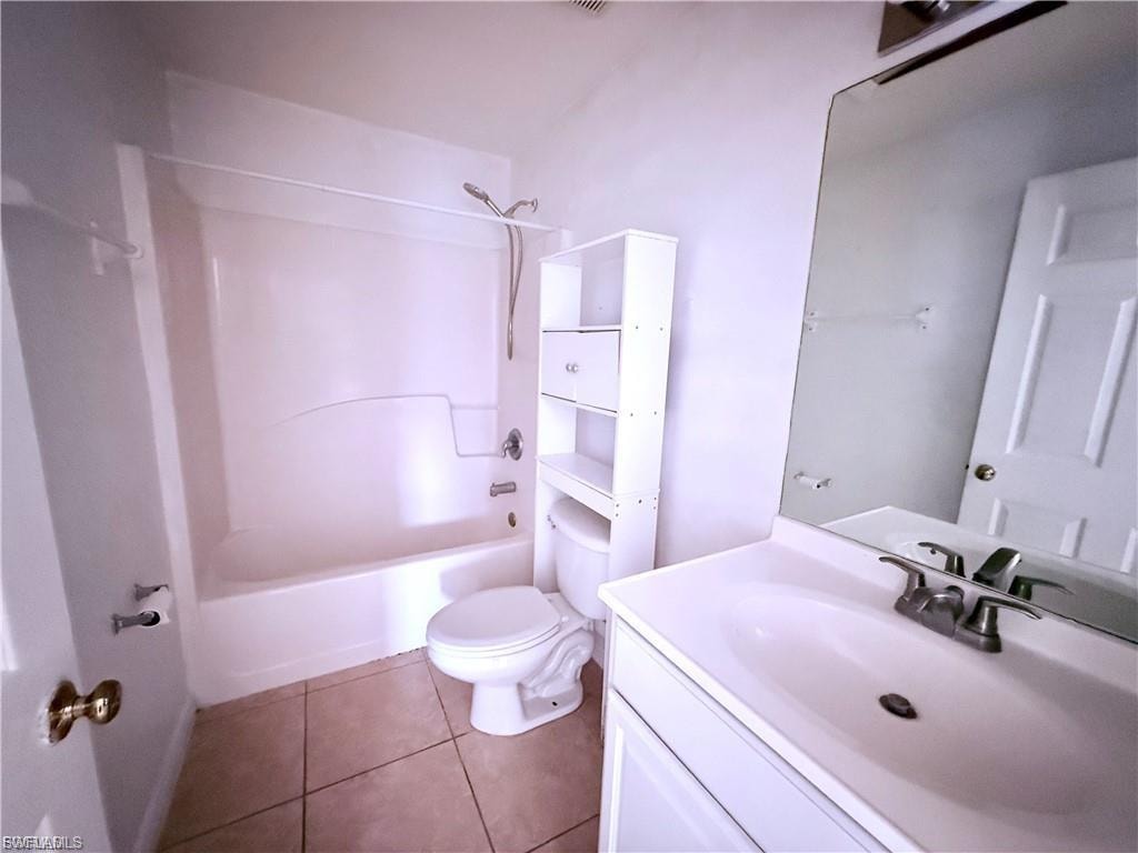 Full bath featuring vanity,  shower combination, and tile patterned flooring