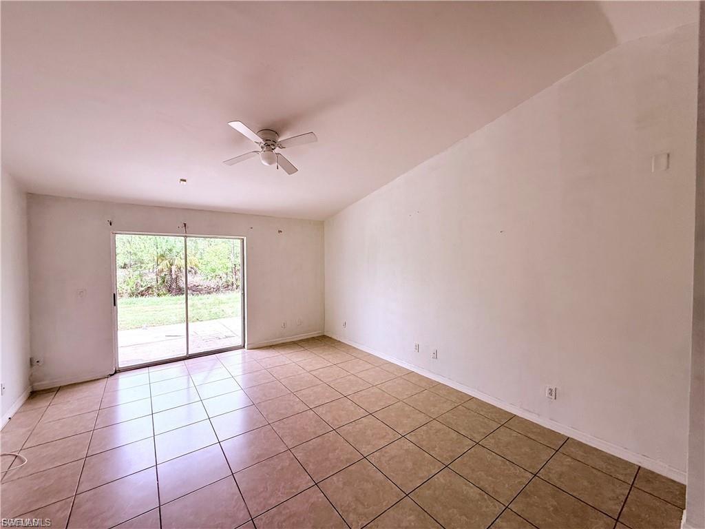 Unfurnished room featuring ceiling fan and light tile patterned flooring