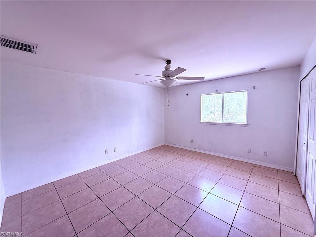 Unfurnished room featuring ceiling fan and light tile patterned flooring