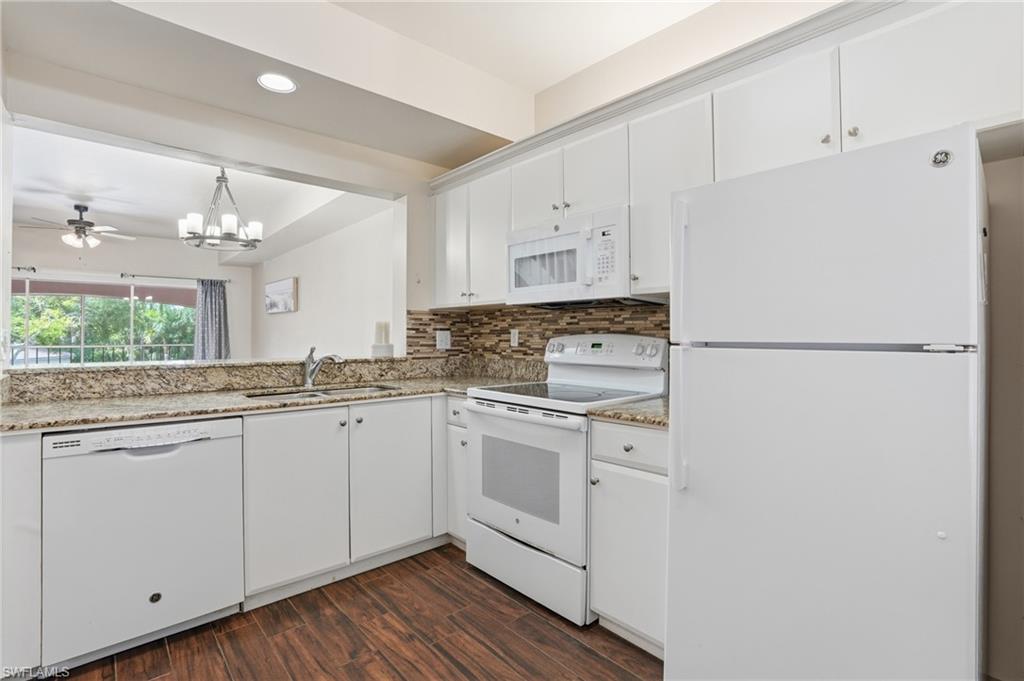 Kitchen featuring white cabinetry, wood-finish flooring, and light-toned countertops